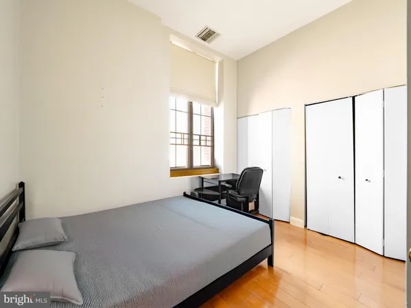 a bedroom with a bed a table and chair
