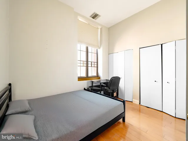 a bedroom with a bed a table and chair