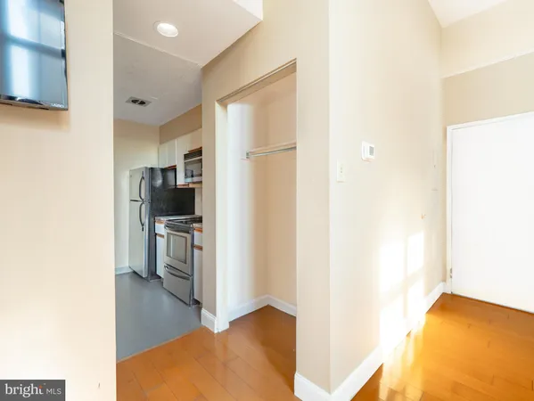 a kitchen with stainless steel appliances a refrigerator and a stove