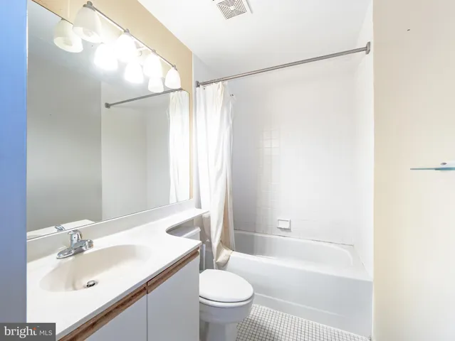 a bathroom with a sink mirror toilet and bathtub