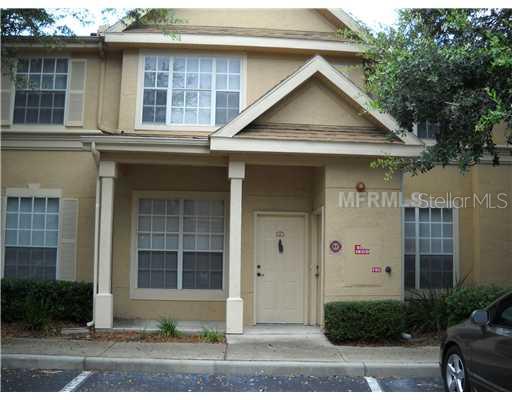 826 Grand Regency Pointe, Unit 101 Altamonte Springs, FL 32714 - Photo 1 of 1 a front view of a house with a yard and garage