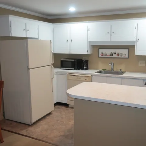 a white refrigerator freezer sitting in a kitchen