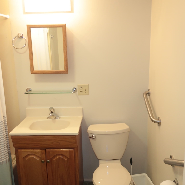 1 Atkinson Drive, Unit 3 Saugus, MA 01906 - Photo 11 of 27 a bathroom with a toilet sink and mirror