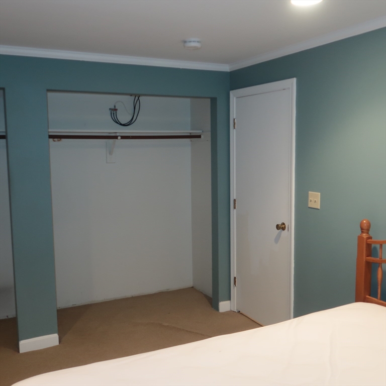 1 Atkinson Drive, Unit 3 Saugus, MA 01906 - Photo 24 of 27 a bedroom with a bed and a table