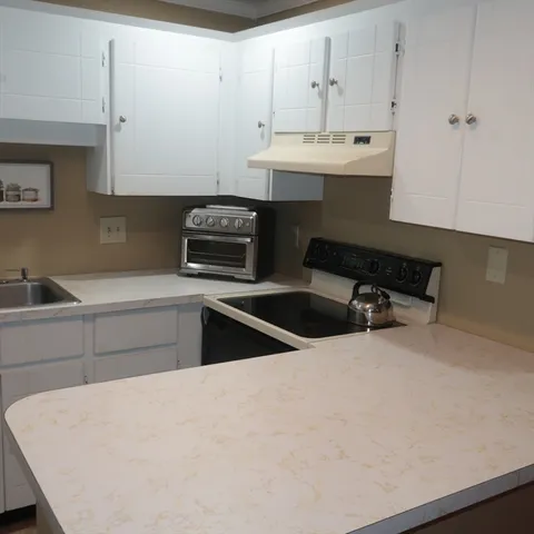 a kitchen that has a sink and a stove