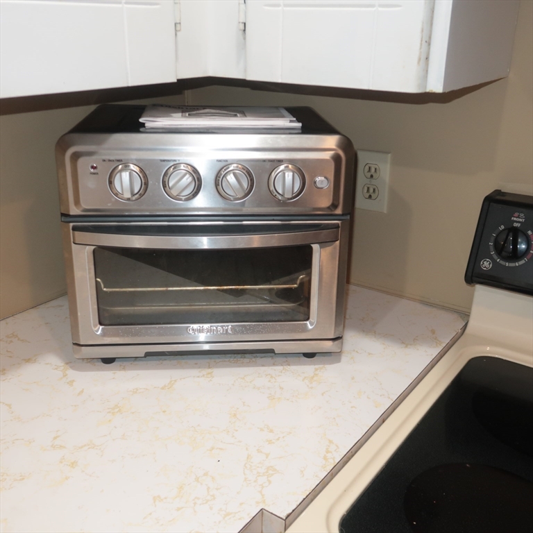 1 Atkinson Drive, Unit 3 Saugus, MA 01906 - Photo 5 of 27 a stove top oven sitting inside of a kitchen