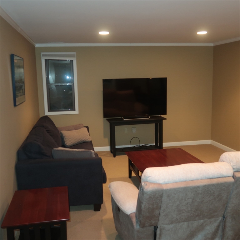 1 Atkinson Drive, Unit 3 Saugus, MA 01906 - Photo 6 of 27 a bedroom with a bed and a flat screen tv