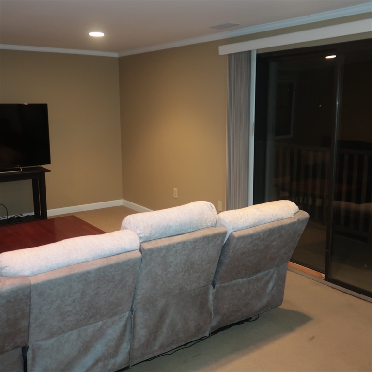 1 Atkinson Drive, Unit 3 Saugus, MA 01906 - Photo 7 of 27 a living room with a couch and a flat screen tv