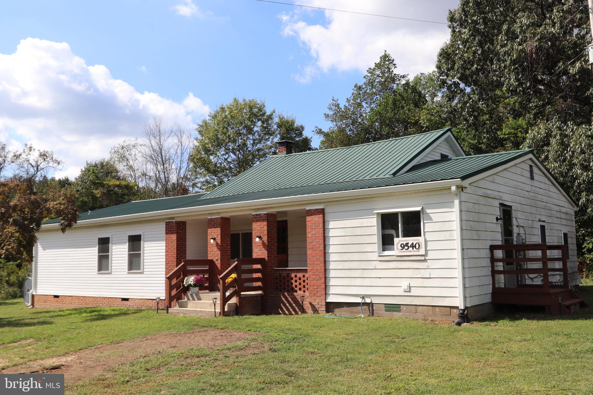 a view of a house with yard and furniture