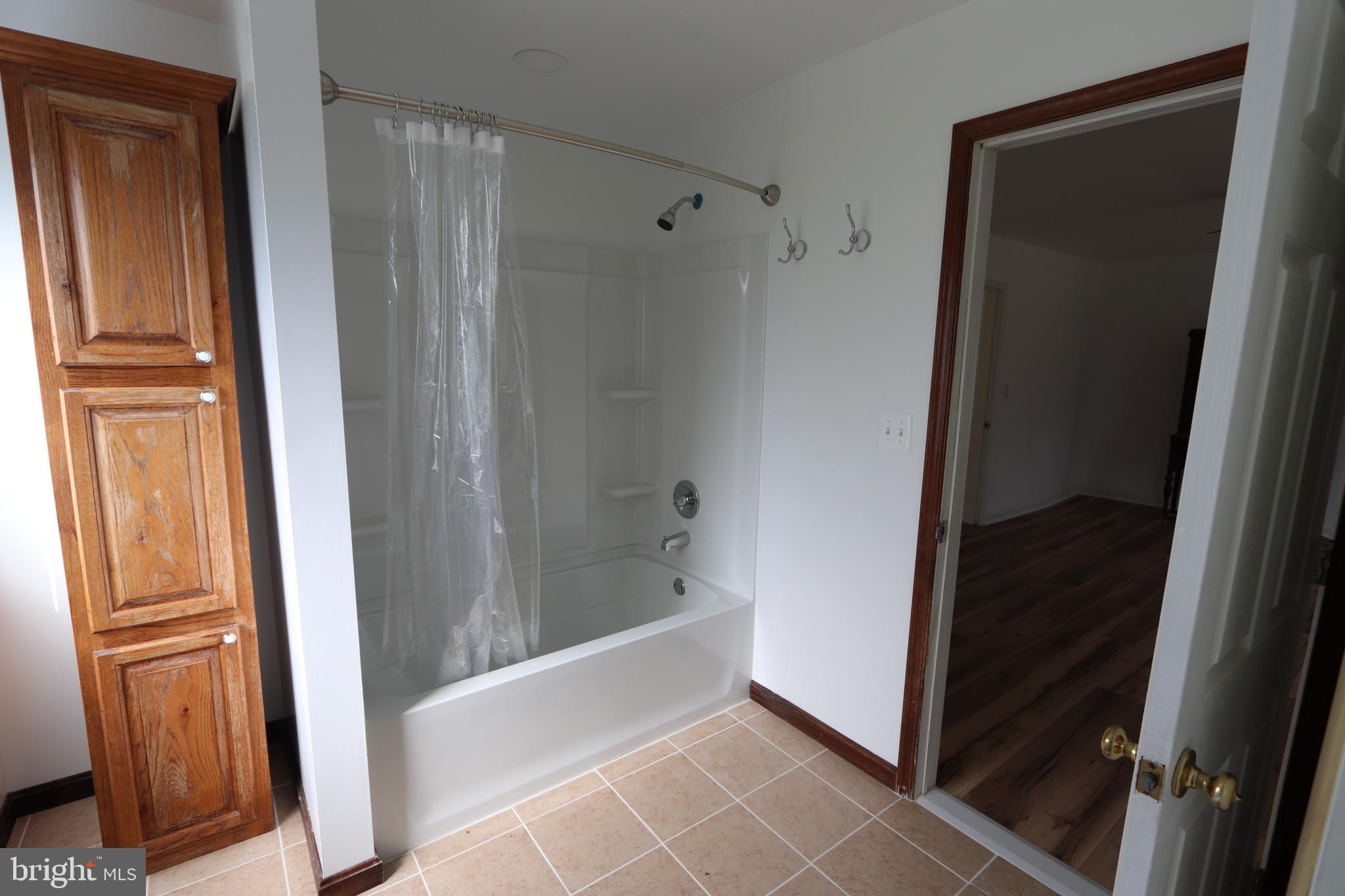 9540 Greenfield Road La Plata, MD 20646 - Photo 11 of 33 a bathroom with a tub and a sink