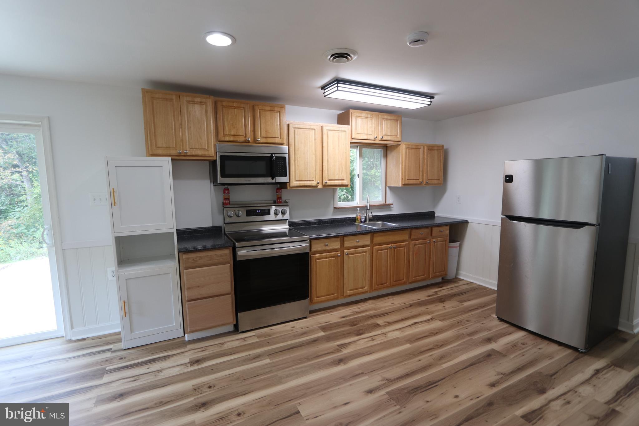 9540 Greenfield Road La Plata, MD 20646 - Photo 3 of 33 a kitchen with granite countertop a refrigerator stove top oven and sink
