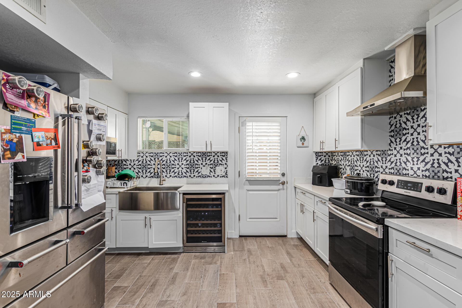 2934 North 22nd Place Phoenix, AZ 85016 - Photo 11 of 27 a kitchen with stainless steel appliances kitchen island granite countertop a stove and a refrigerator