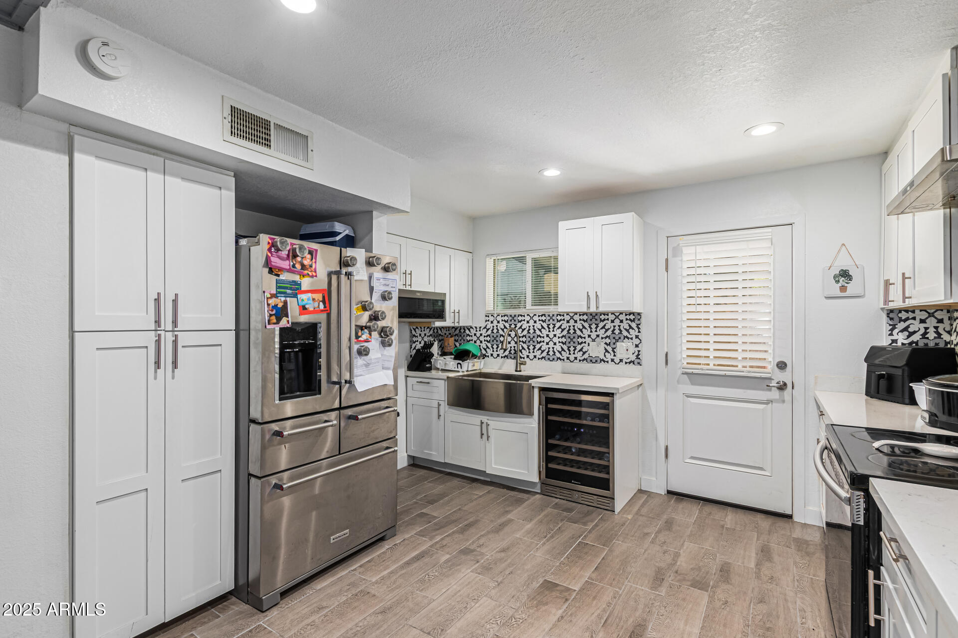 2934 North 22nd Place Phoenix, AZ 85016 - Photo 12 of 27 a kitchen with cabinets and stainless steel appliances