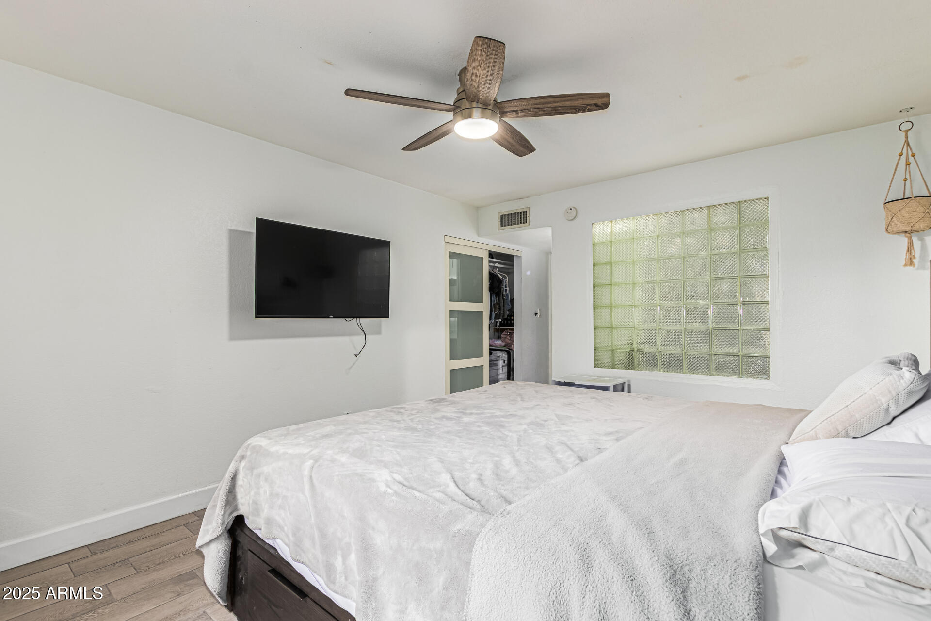 2934 North 22nd Place Phoenix, AZ 85016 - Photo 15 of 27 a bedroom with a bed and a flat screen tv