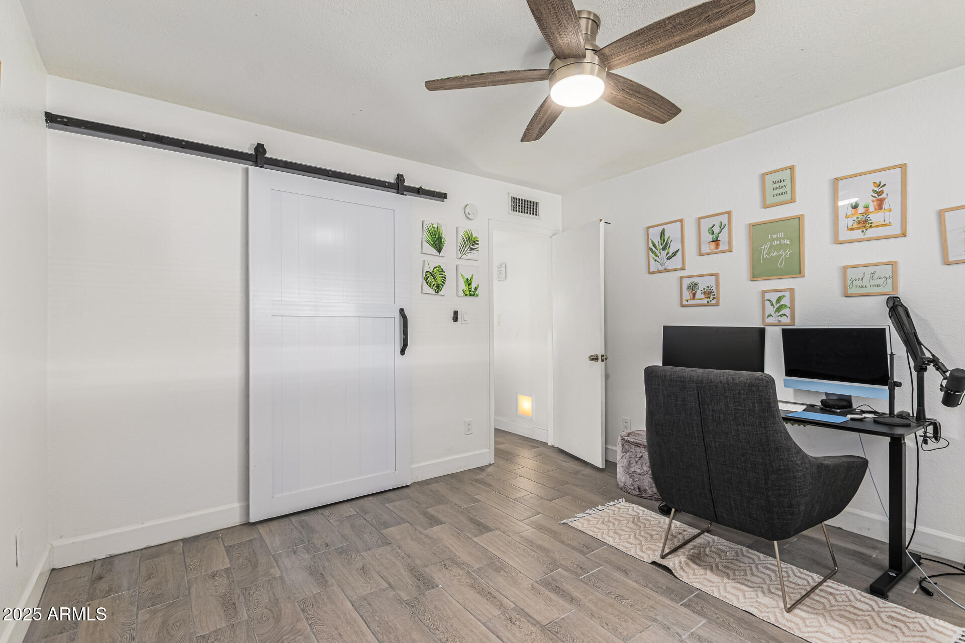 2934 North 22nd Place Phoenix, AZ 85016 - Photo 18 of 27 a view of a workspace with furniture and a ceiling fan