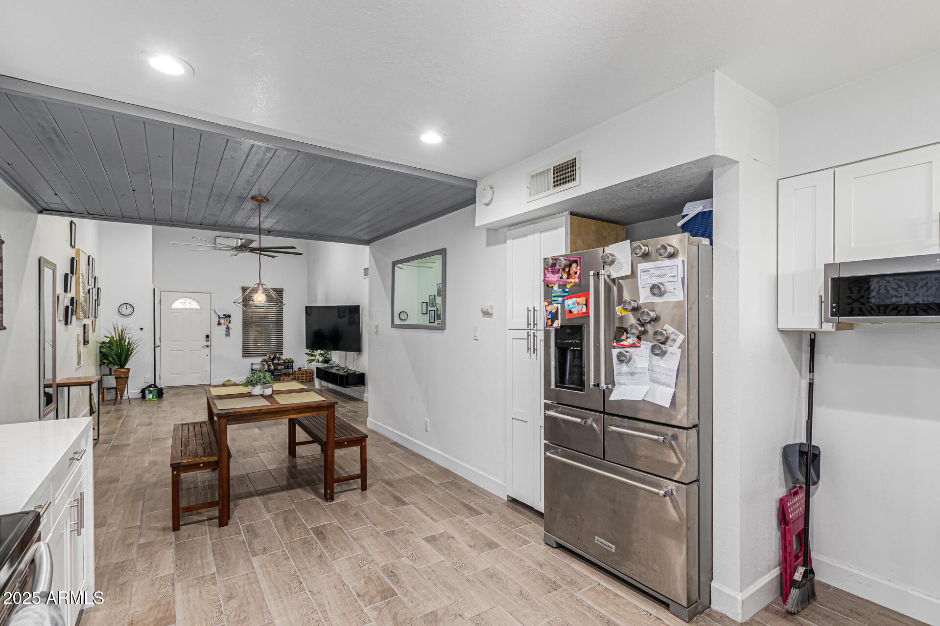 2934 North 22nd Place Phoenix, AZ 85016 - Photo 9 of 27 a kitchen with stainless steel appliances a refrigerator and wooden floor
