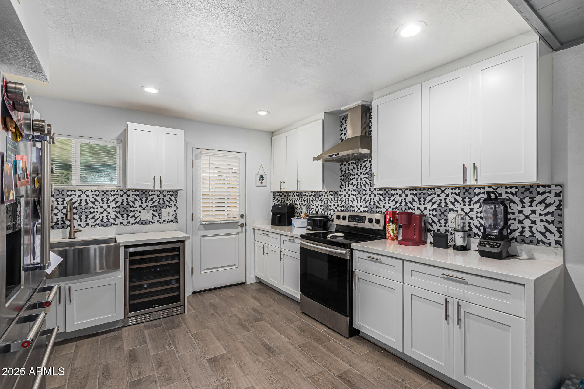 2934 North 22nd Place Phoenix, AZ 85016 - Photo 10 of 27 a kitchen with white cabinets stainless steel appliances and sink