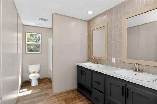 a bathroom with a double vanity sink and a mirror