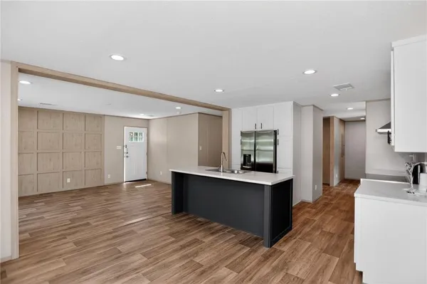 a view of kitchen with cabinets appliances and wooden floor