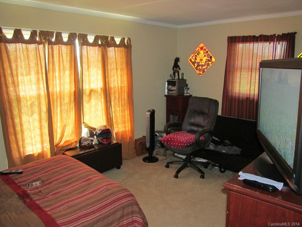 902 Tomberlin Road Monroe, NC 28110 - Photo 11 of 21 a bedroom with a bed and large windows
