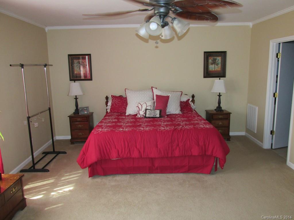 902 Tomberlin Road Monroe, NC 28110 - Photo 13 of 21 a bed room with a bed and a chandelier