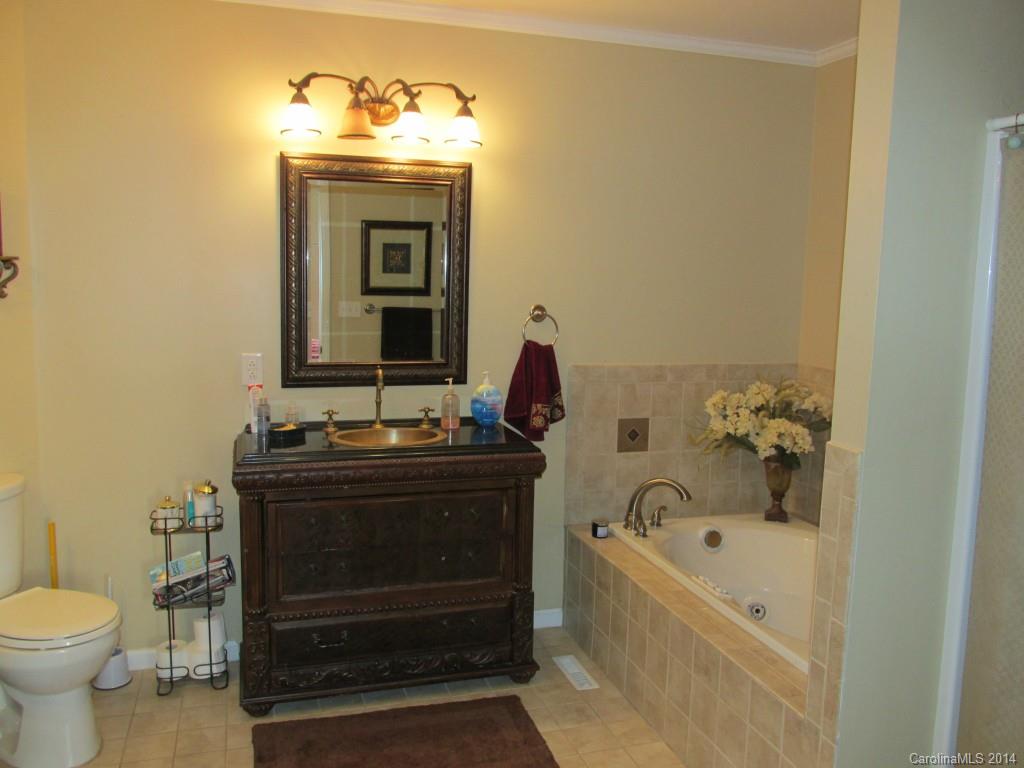 902 Tomberlin Road Monroe, NC 28110 - Photo 14 of 21 a bathroom with a sink and a bathtub