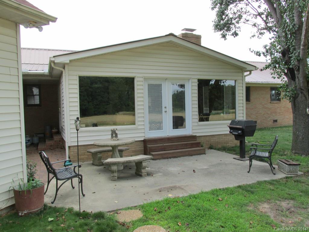 902 Tomberlin Road Monroe, NC 28110 - Photo 21 of 21 a front view of a house with a garden and chairs