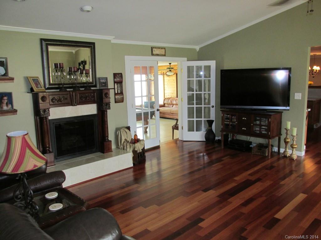 902 Tomberlin Road Monroe, NC 28110 - Photo 4 of 21 a living room with furniture a flat screen tv and a fireplace