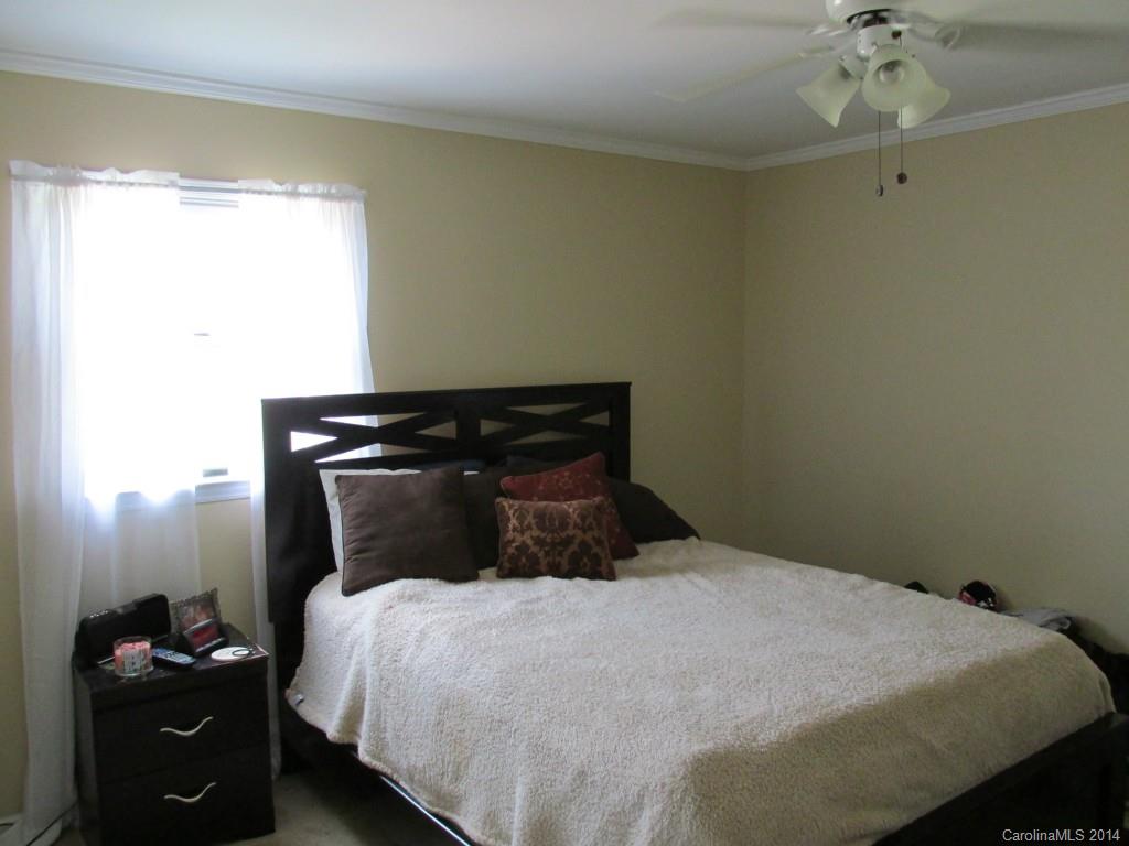 902 Tomberlin Road Monroe, NC 28110 - Photo 10 of 21 a bedroom with a bed and a chandelier