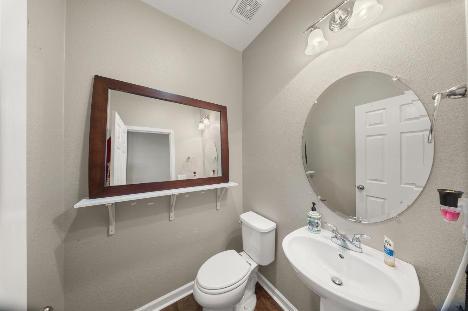 2685 Remy Javier Street Tracy, CA 95377 - Photo 11 of 26 a bathroom with a toilet sink and mirror