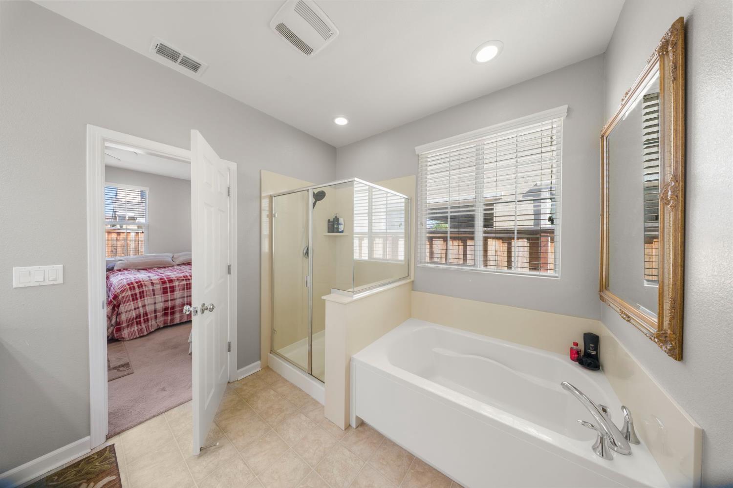 2685 Remy Javier Street Tracy, CA 95377 - Photo 22 of 26 a bathroom with a bathtub and a shower