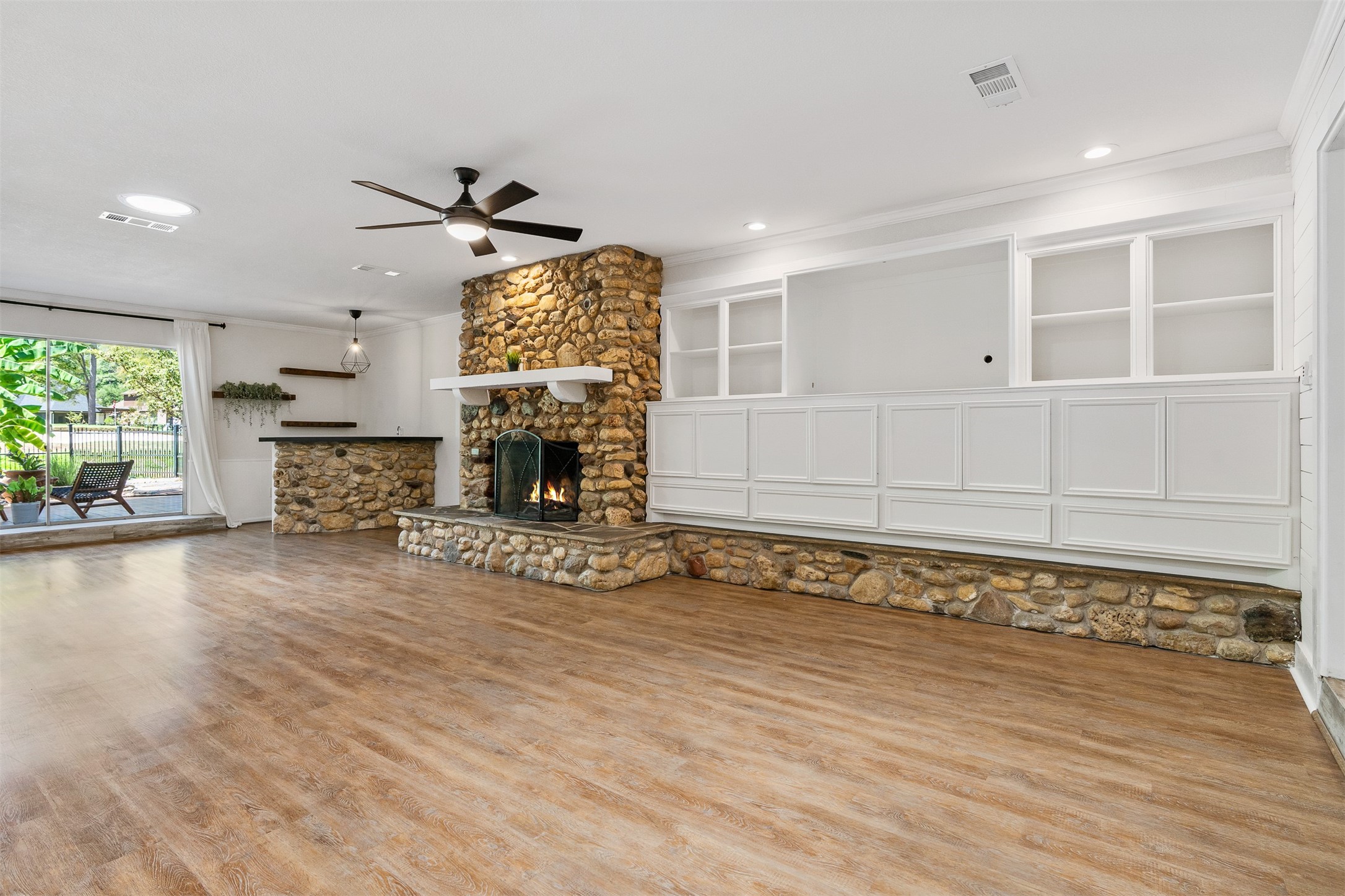 3219 Chippers Crossing Montgomery, TX 77356 - Photo 12 of 35 a view of an empty room with a fireplace and a window