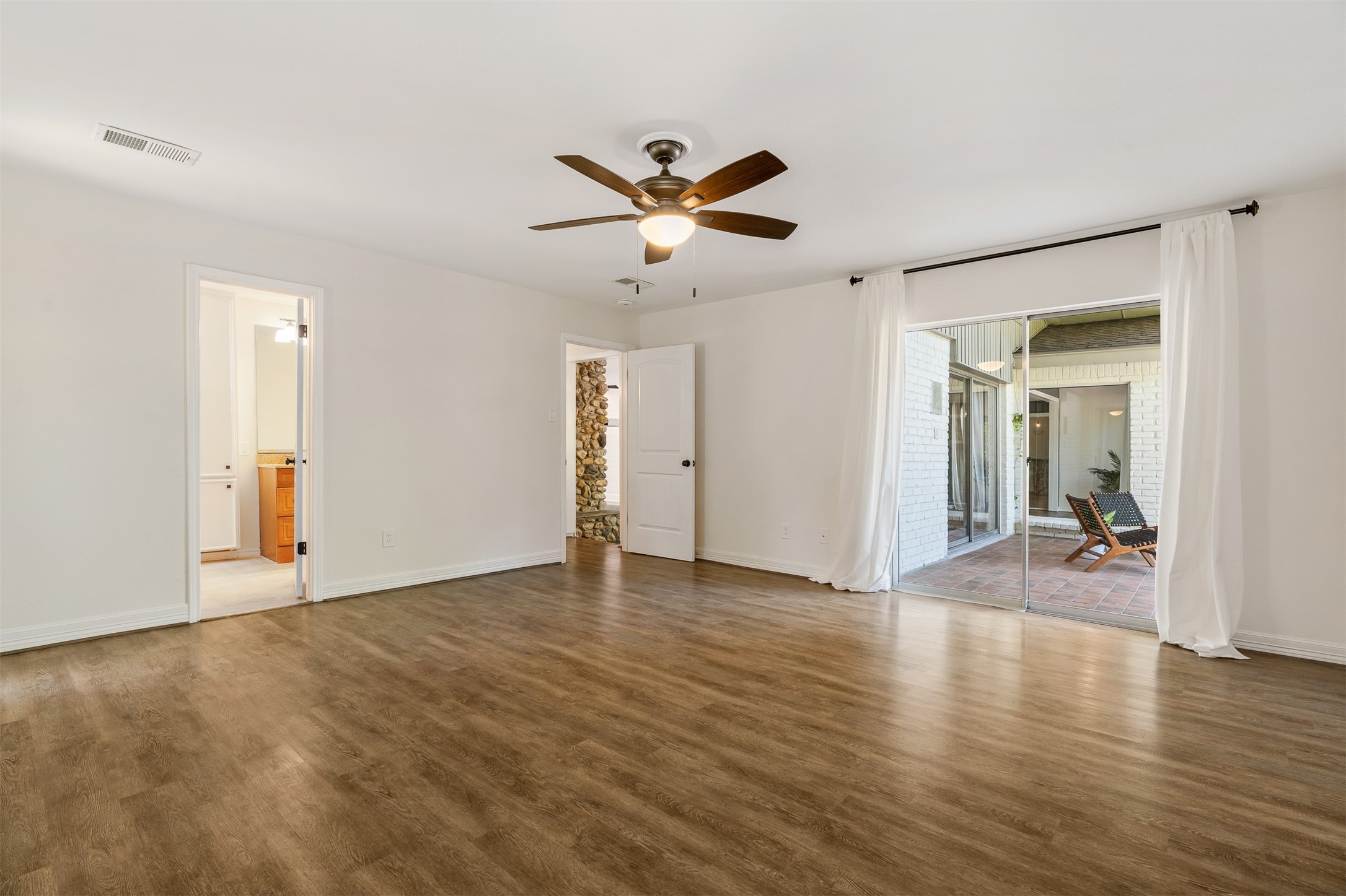 3219 Chippers Crossing Montgomery, TX 77356 - Photo 18 of 35 wooden floor in an empty room with a window