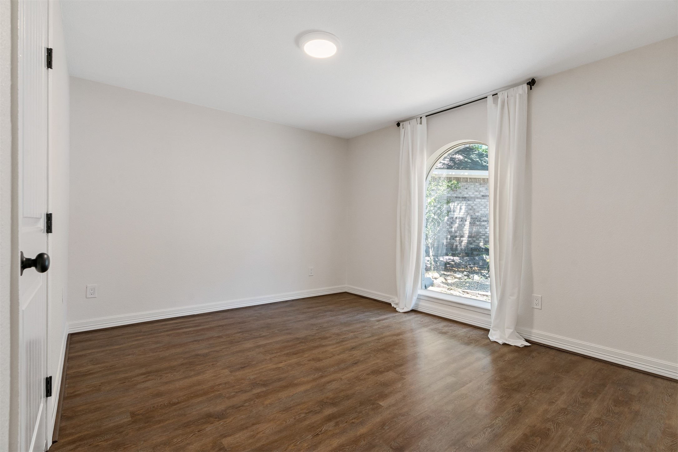 3219 Chippers Crossing Montgomery, TX 77356 - Photo 22 of 35 an empty room with wooden floor and windows