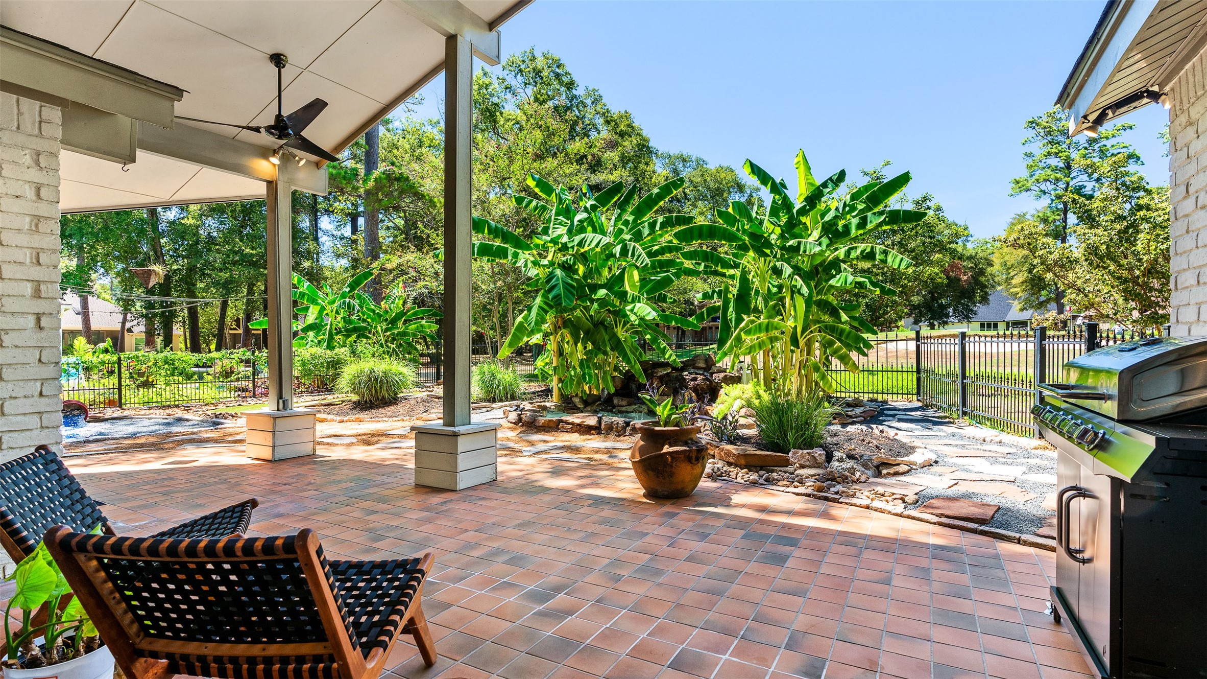 3219 Chippers Crossing Montgomery, TX 77356 - Photo 30 of 35 a view of a patio with table and chairs potted plants with wooden fence