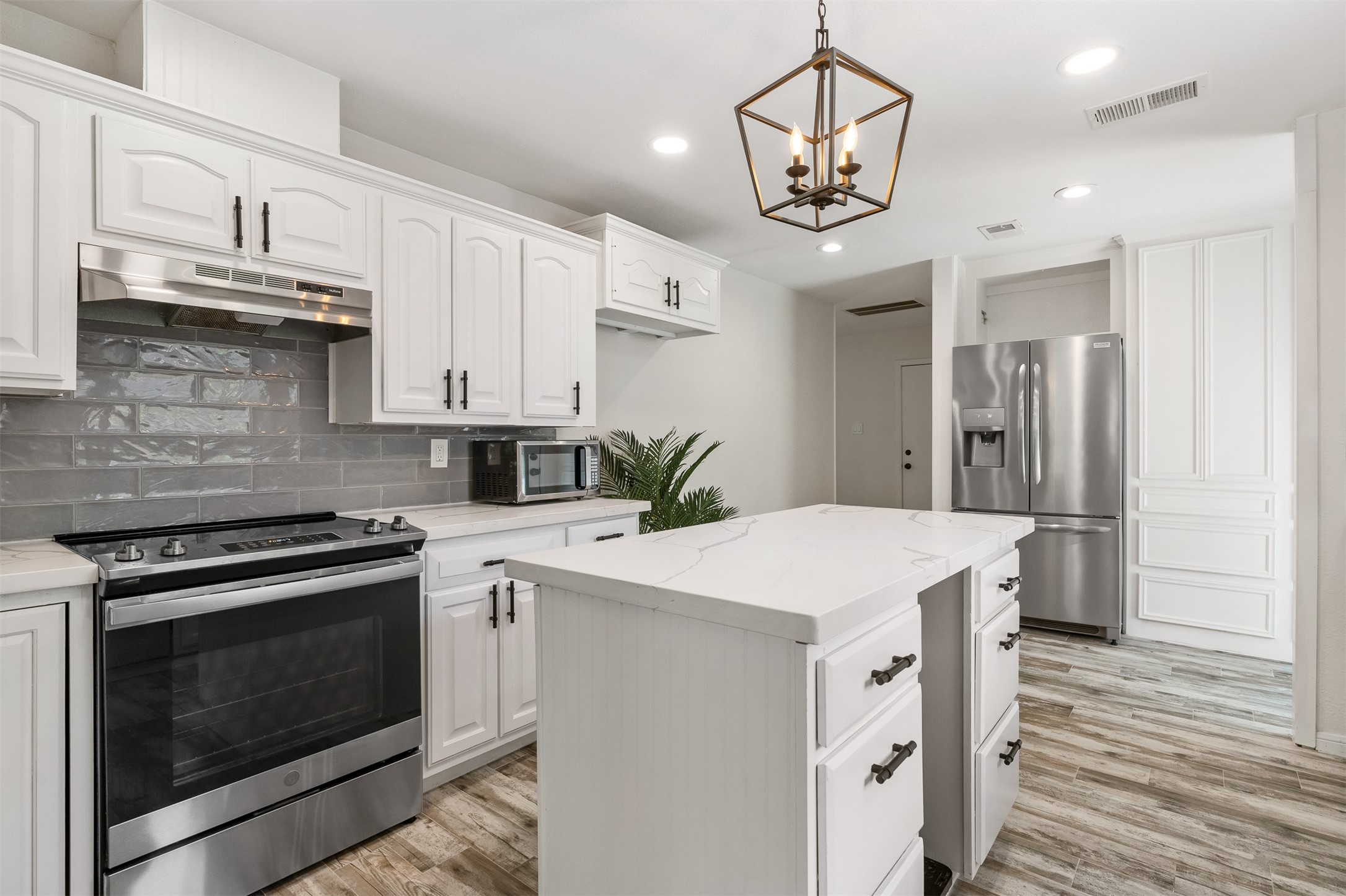3219 Chippers Crossing Montgomery, TX 77356 - Photo 7 of 35 a kitchen with stainless steel appliances a white stove top oven and cabinets