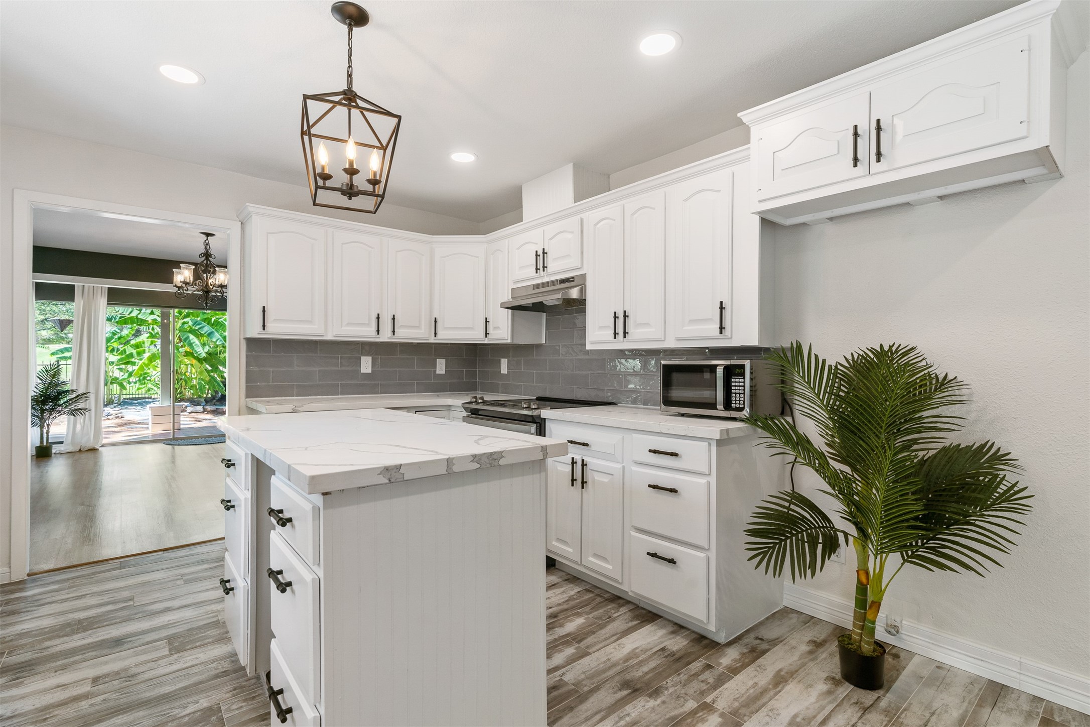 3219 Chippers Crossing Montgomery, TX 77356 - Photo 8 of 35 a kitchen with stainless steel appliances kitchen island a white cabinets and wooden floor