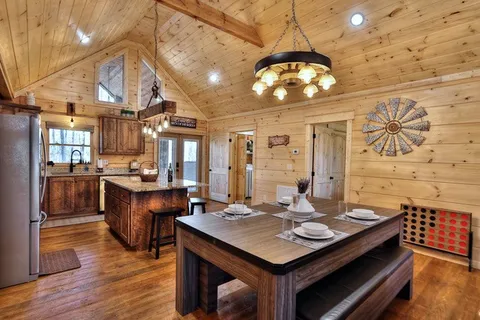 a large kitchen with a table and chairs