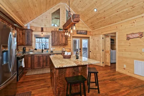 a bedroom with a bed wooden floor and window