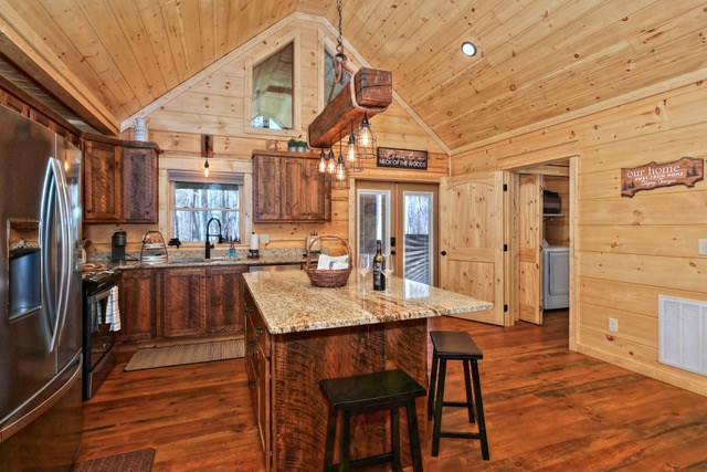 956 Lemmon Lane Ellijay, GA 30540 - Photo 18 of 60 a kitchen with granite countertop a table chairs stainless steel appliances and cabinets
