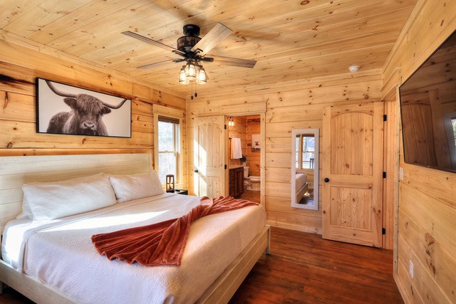 956 Lemmon Lane Ellijay, GA 30540 - Photo 23 of 60 a bedroom with a bed and a chandelier