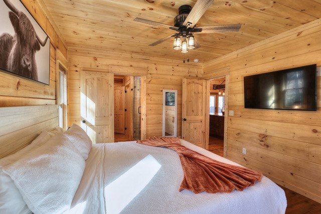 956 Lemmon Lane Ellijay, GA 30540 - Photo 26 of 60 a spacious bedroom with a bed and a flat screen tv