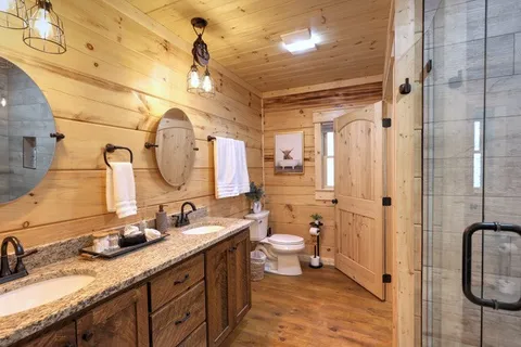 a bathroom with a granite countertop sink a toilet and bathtub