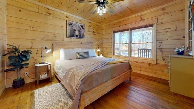 956 Lemmon Lane Ellijay, GA 30540 - Photo 32 of 60 a bedroom with a bed and wooden floor