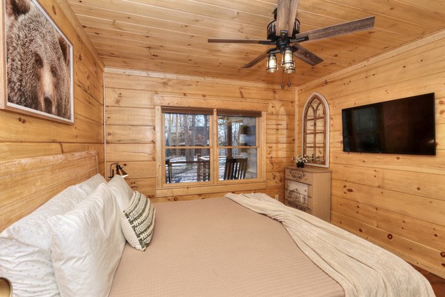 956 Lemmon Lane Ellijay, GA 30540 - Photo 35 of 60 a spacious bedroom with a bed and a flat screen tv