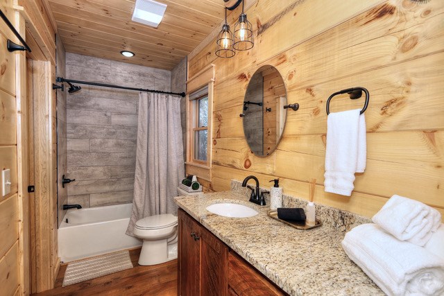 956 Lemmon Lane Ellijay, GA 30540 - Photo 36 of 60 a bathroom with a granite countertop sink a toilet and bathtub