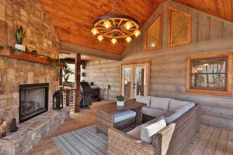 a living room with stainless steel appliances kitchen island granite countertop furniture and a wooden floor