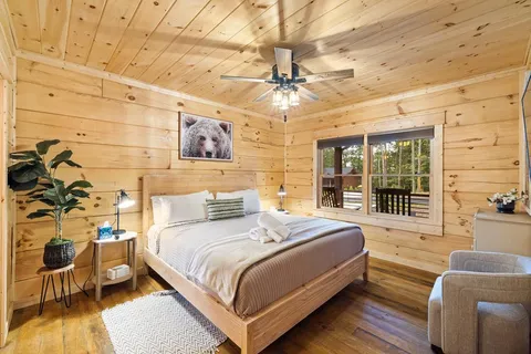 a living room with furniture a fireplace and a floor to ceiling window