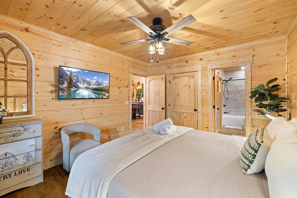 956 Lemmon Lane Ellijay, GA 30540 - Photo 47 of 60 a bedroom with a bed and a chandelier