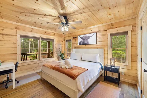 a front view of a house with a yard and trees